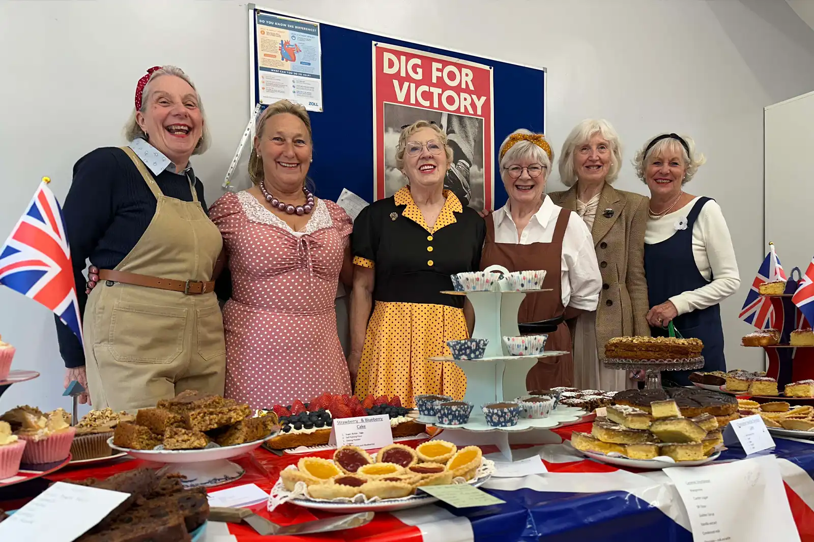 Picture showing the cakes and fashions on show at the VE Day 8oth Celebrations